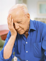 Un hombre mayor tiene la cabeza apoyada en la mano como si tuviera dificultad para recordar algo