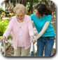 Elderly woman is walking with the help of her granddaughter