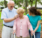 elderly woman crying, friends offering support