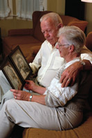 elderly couple looking at photos