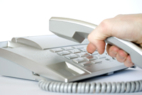 person dialing telephone number
