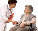 provider talking to elderly woman in wheelchair