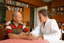 provider talking to man in library