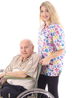 Female provider is happily pushing an elderly man in a wheelchair